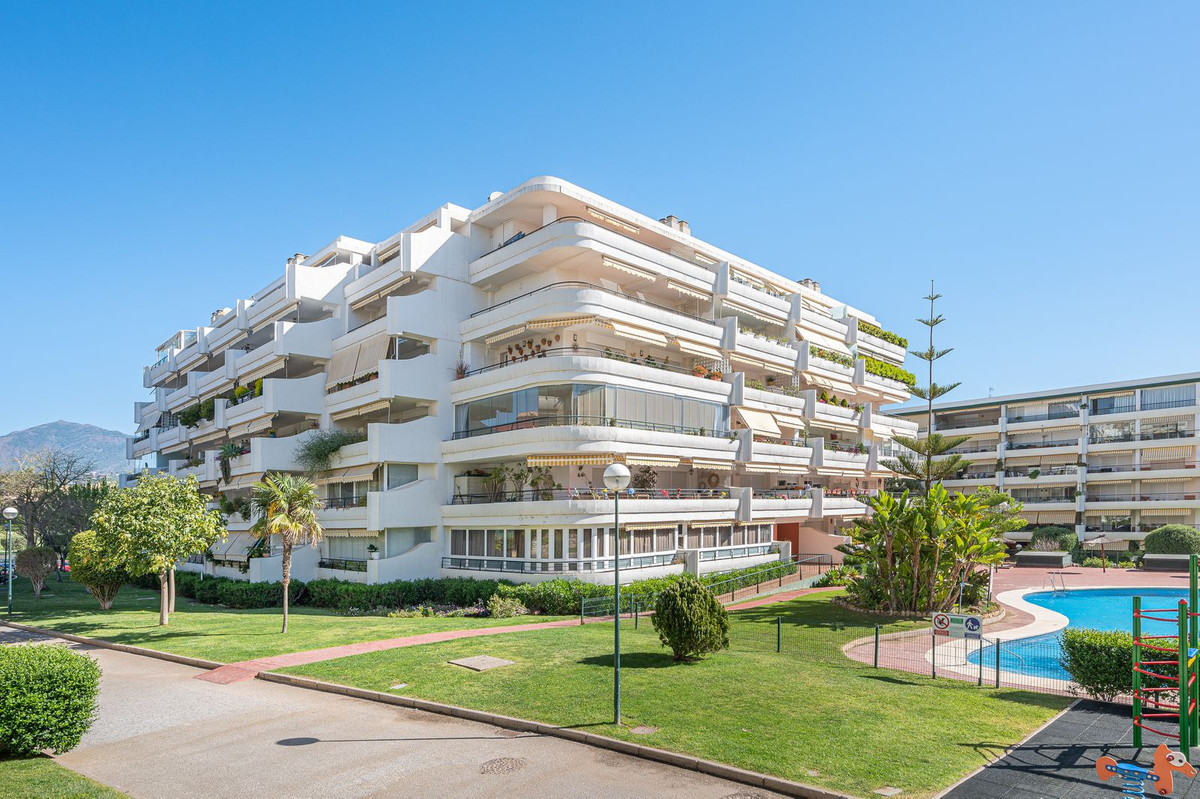 Luxurious Guadalmina apartment with sea views, terraces, and modern amenities.