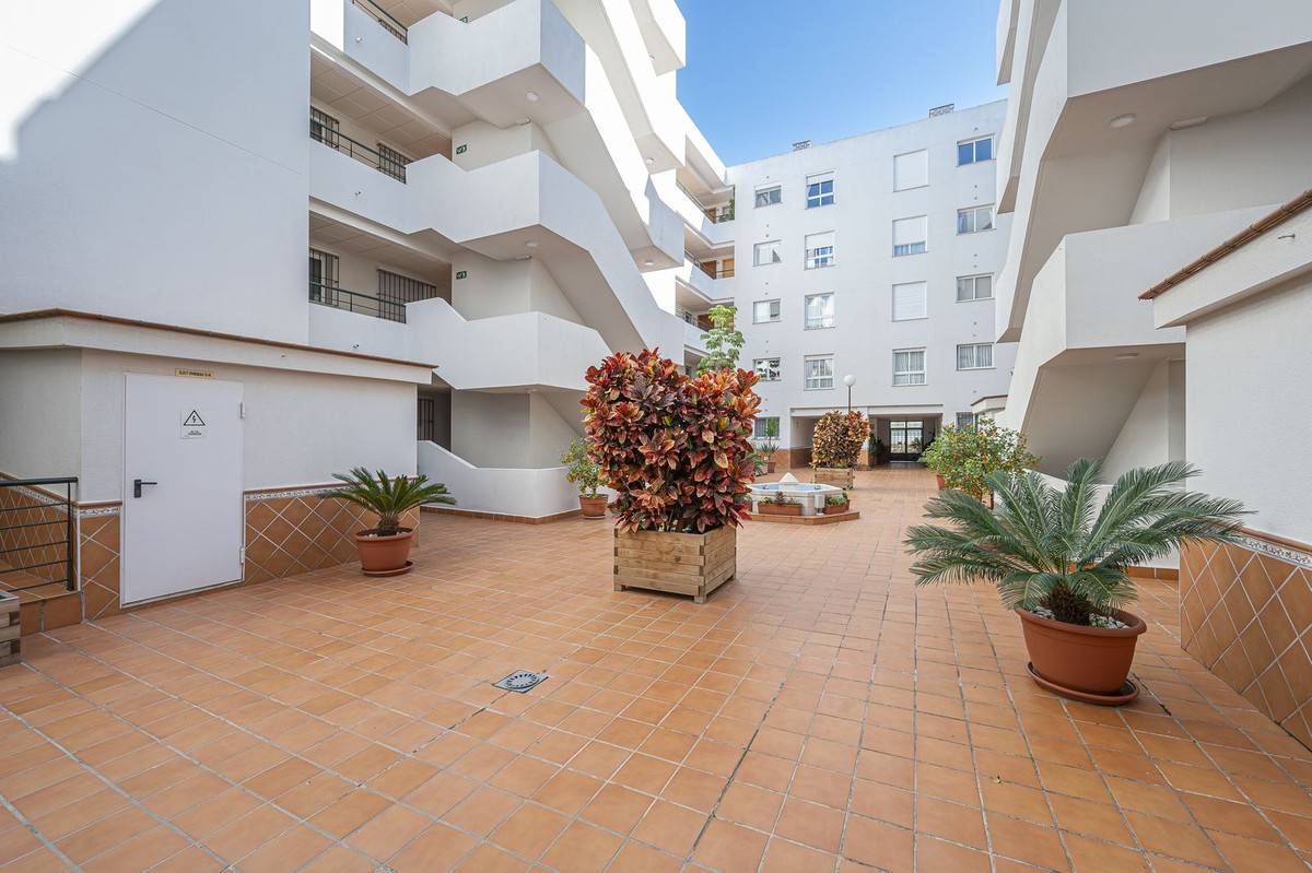 Luxurious Guadalmina apartment with sea views, terraces, and modern amenities.