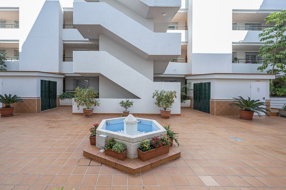 Luxurious Guadalmina apartment with sea views, terraces, and modern amenities.