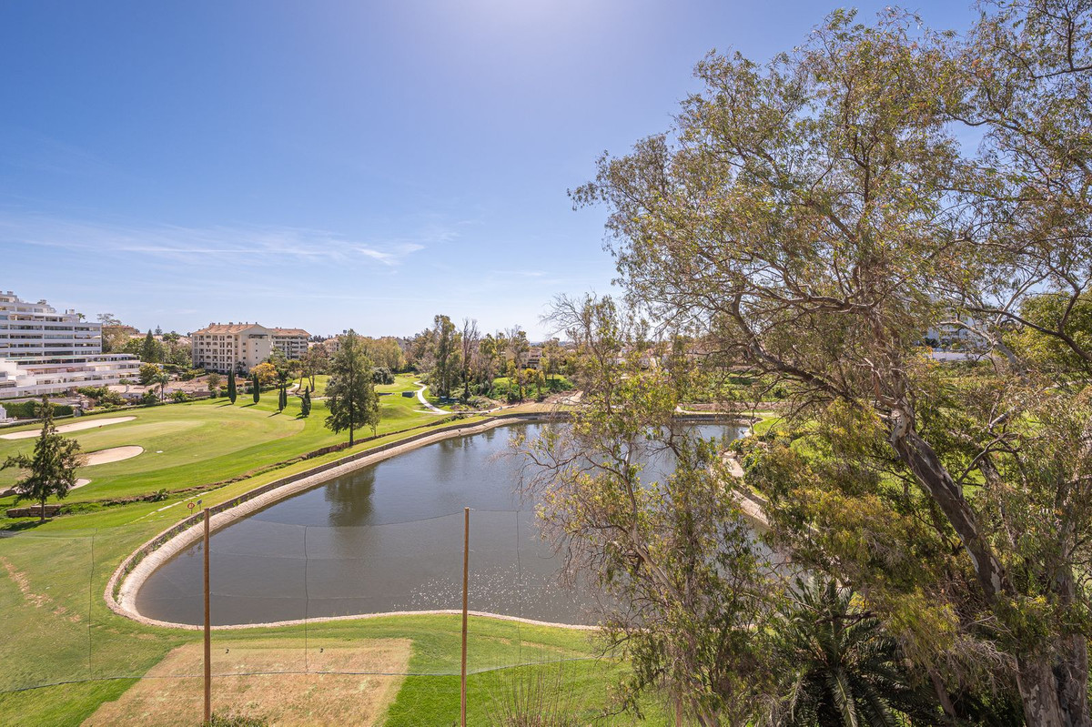 Luxurious Guadalmina apartment with sea views, terraces, and modern amenities.