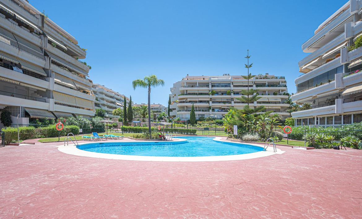 Luxurious Guadalmina apartment with sea views, terraces, and modern amenities.