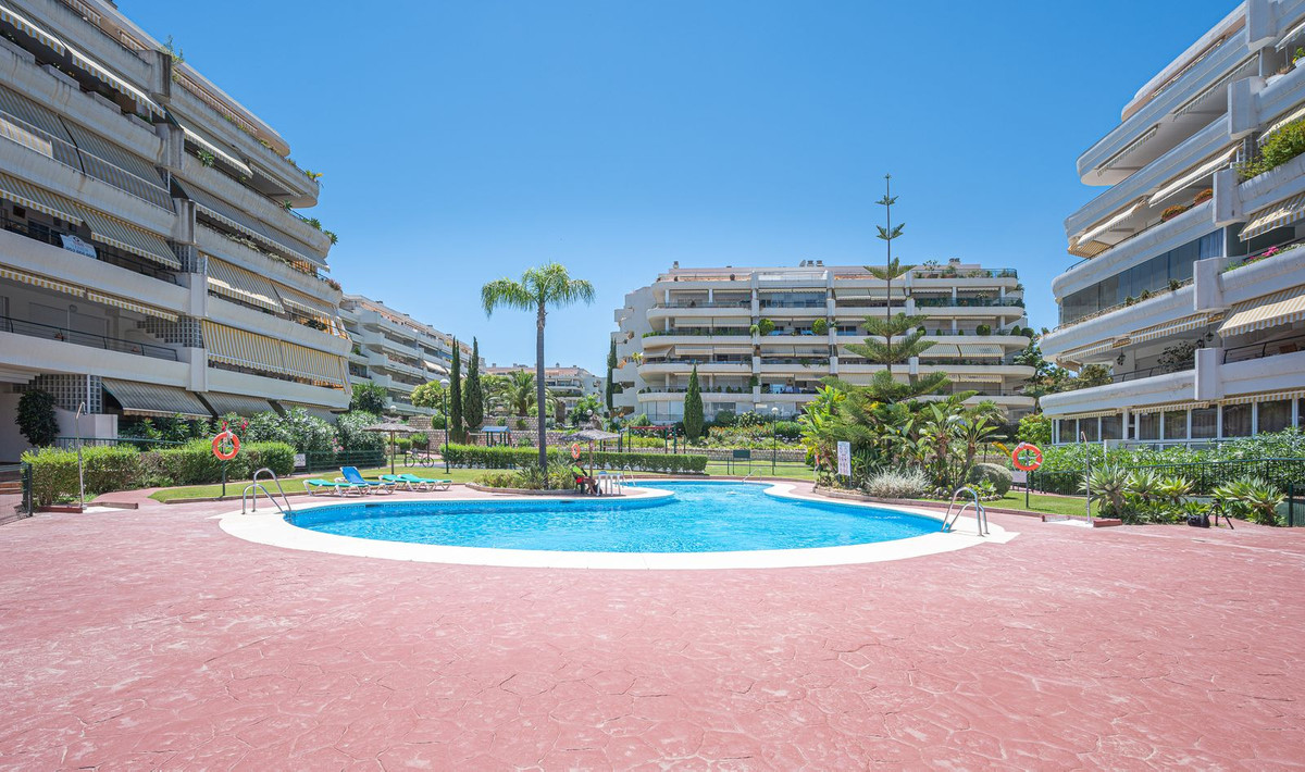 Luxurious Guadalmina apartment with sea views, terraces, and modern amenities.