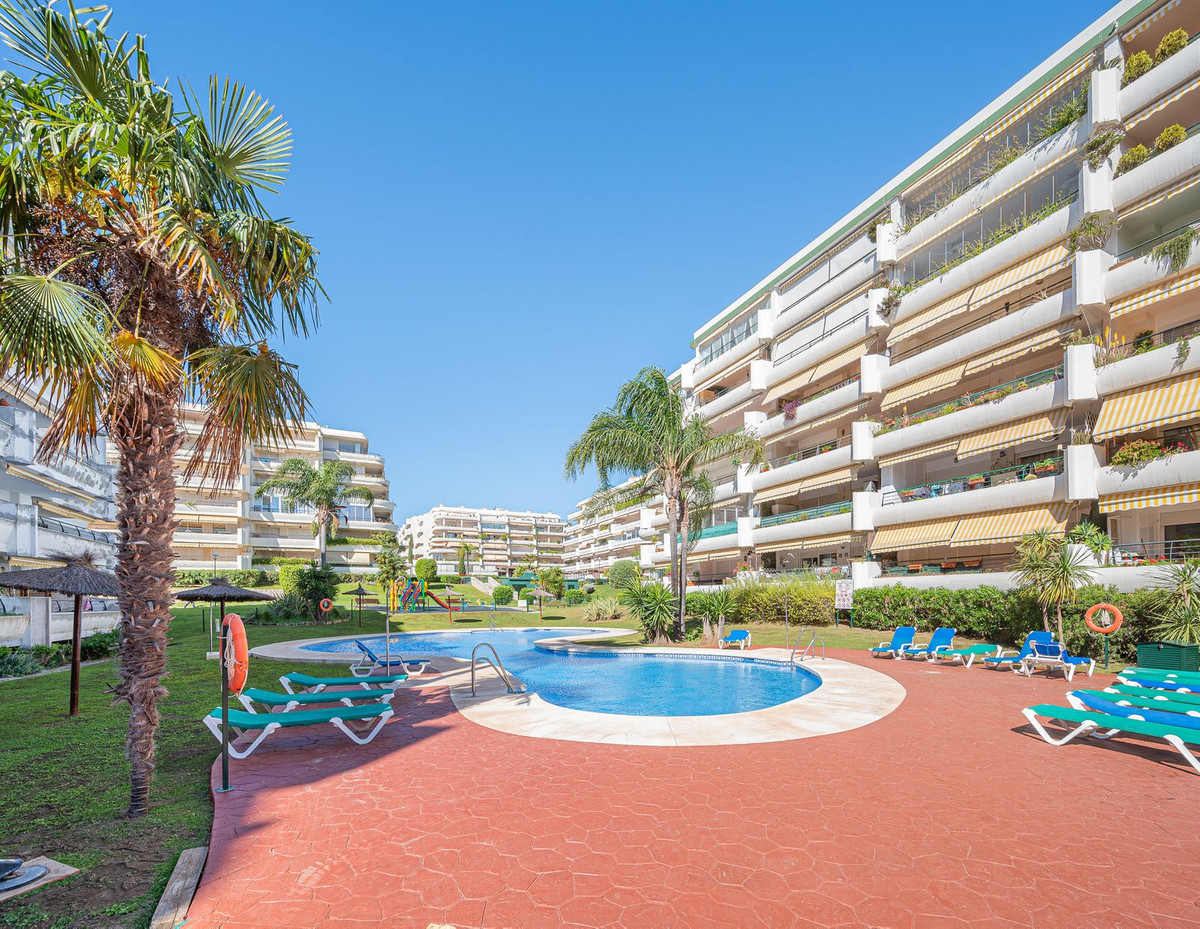 Luxurious Guadalmina apartment with sea views, terraces, and modern amenities.