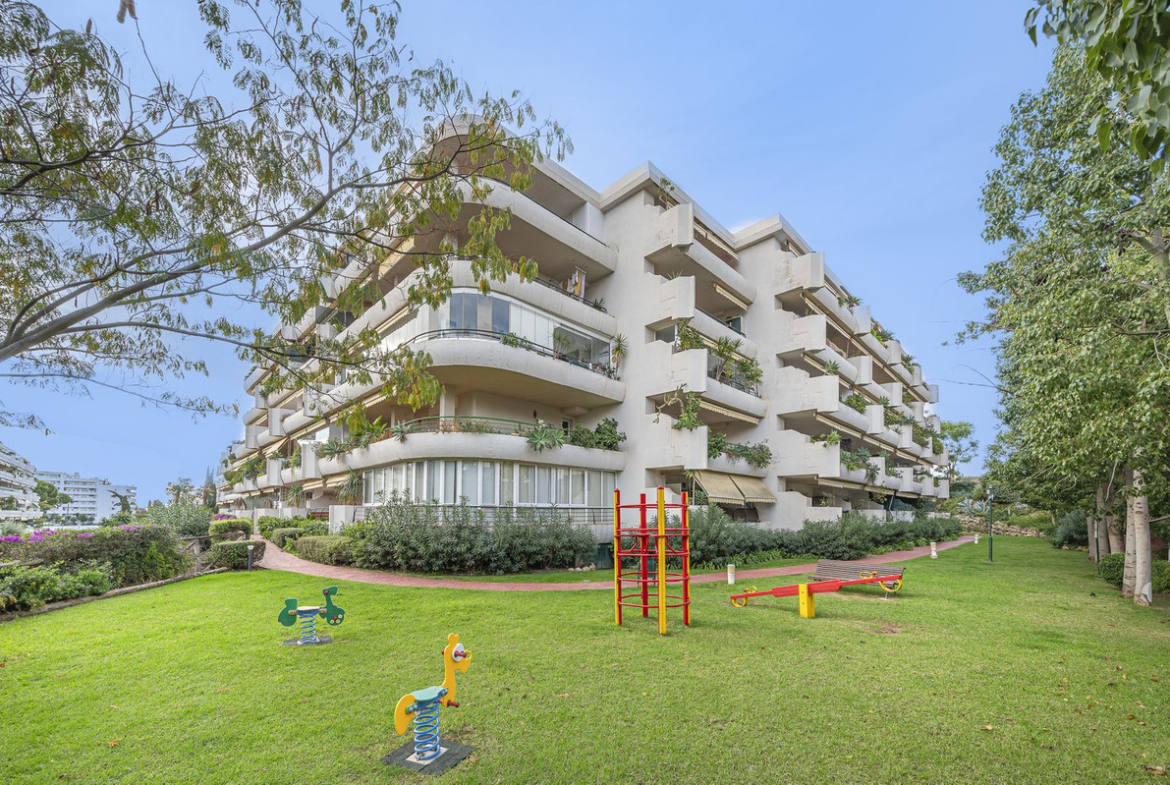 Luxurious Guadalmina apartment with sea views, terraces, and modern amenities.