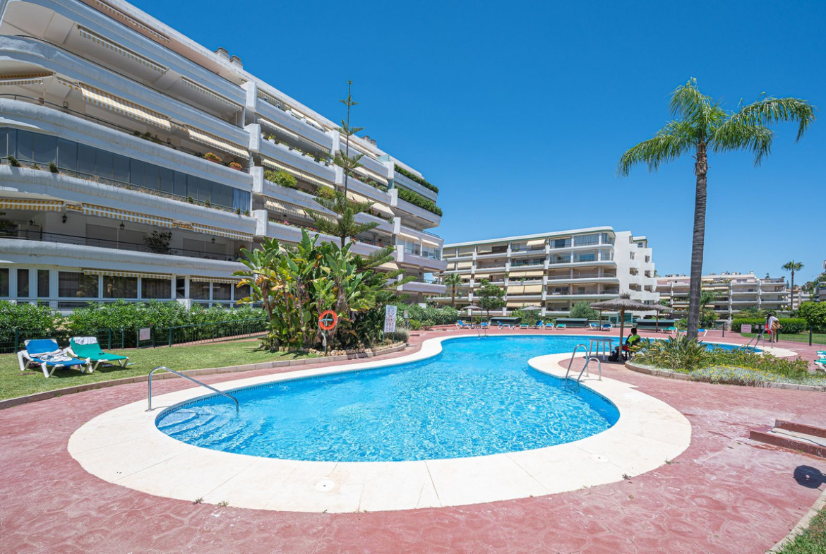 Luxurious Guadalmina apartment with sea views, terraces, and modern amenities.