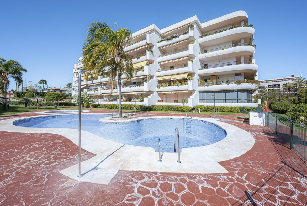 Luxurious Guadalmina apartment with sea views, terraces, and modern amenities.