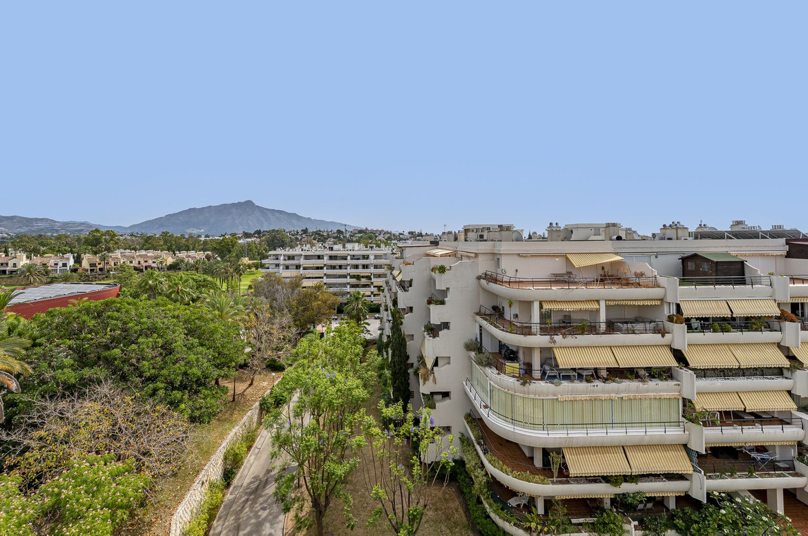 Luxurious Guadalmina apartment with sea views, terraces, and modern amenities.