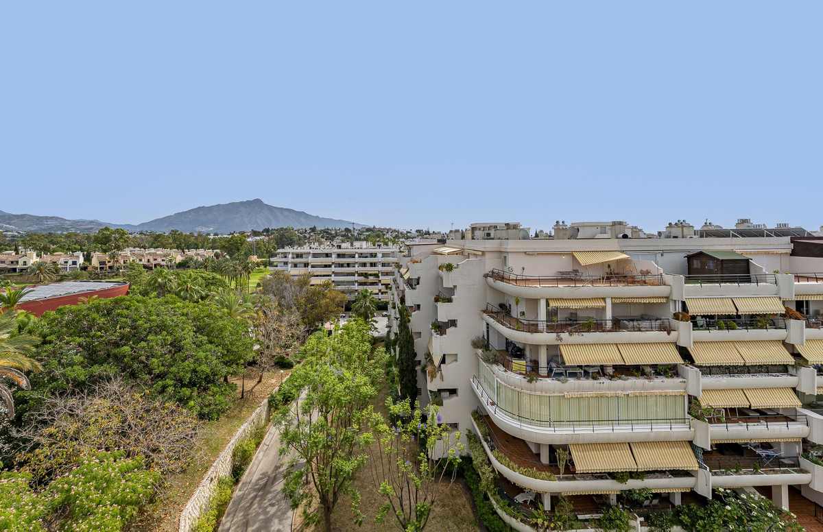 Luxurious Guadalmina apartment with sea views, terraces, and modern amenities.