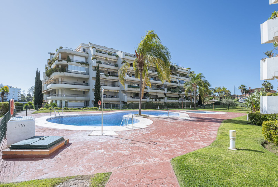 Luxurious Guadalmina apartment with sea views, terraces, and modern amenities.