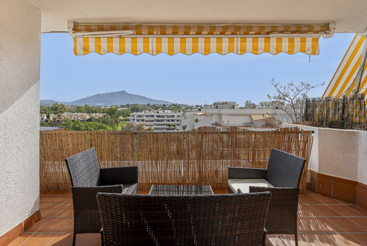 Luxurious Guadalmina apartment with sea views, terraces, and modern amenities.