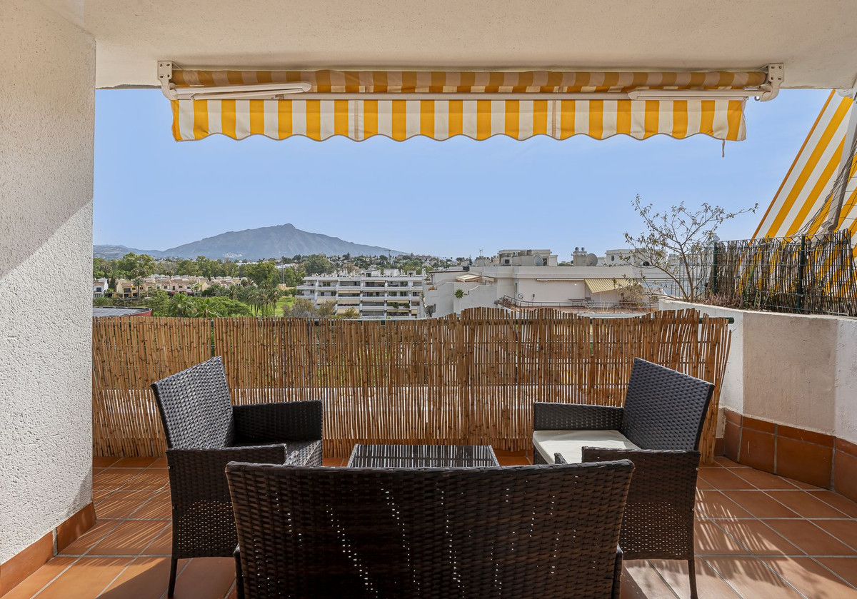 Luxurious Guadalmina apartment with sea views, terraces, and modern amenities.