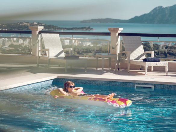 Aerial shot of Mallorca’s coastline with hotels and beachgoers enjoying the sun